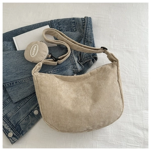 Close-up of beige corduroy hobo bag texture with a detachable fashion coin purse