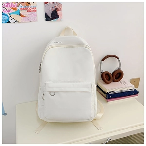 Detailed close-up of white canvas backpack with minimalist graphic icons and metal loop ring