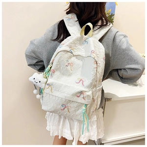 Detailed back view of white nylon backpack with bow embroidery and plush cloud charm