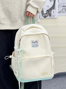 Detail of Korean style backpack with mint green ribbon and aesthetic wings pattern print