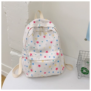 Detail of white canvas backpack with colorful star prints and cotton rope zipper pulls