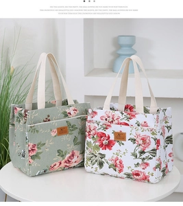 Detail of floral bucket lunch bag featuring front zipper pocket and reinforced handles