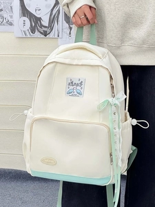 Detail of white and mint green canvas backpack with sweet ribbon bow and zipper pocket