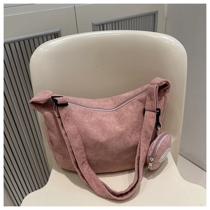 Pink corduroy crossbody bag detail showing adjustable strap and mini round coin purse charm