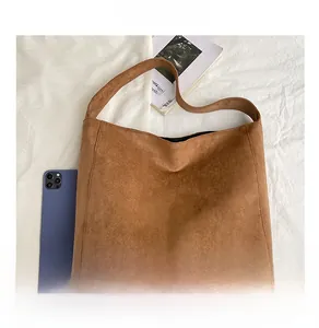Detailed top view of a large brown suede tote bag with a minimalist hobo design