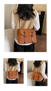 Detail of retro brown faux suede messenger bag with dark brown strap and metal buckle