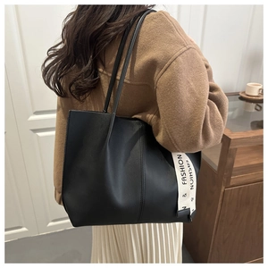 Detail view of large black tote bag with fashion letter strap for commuting