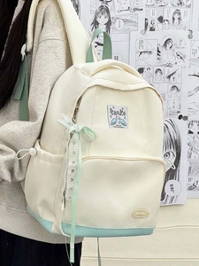Detail view of canvas backpack with ribbon bow and contrast panel in campus style