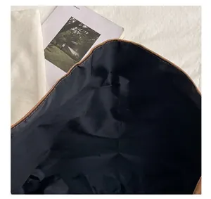 Detail view of the brown suede tote bag featuring its convenient open-top design and lining