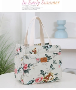Detail showing high-quality floral canvas fabric and leather fashion label on bucket tote bag