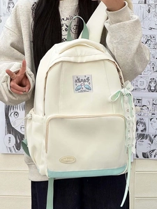 Detail of cream backpack with mint green panel and lace ribbon bow decoration