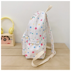 Detail of white canvas backpack featuring colorful star prints and side pocket
