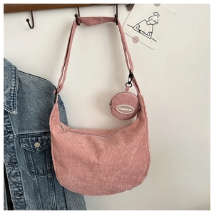 Detail of pink corduroy half-moon crossbody bag with a round matching coin purse