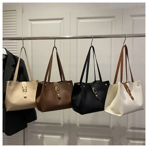 Macro shot of minimalist tote bags in four colors with gold buckle and shoulder straps