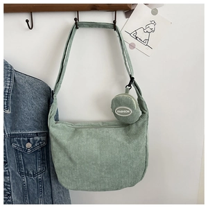 Detail of light green corduroy shoulder bag with detachable matching round coin purse