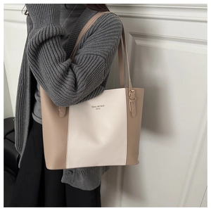 Detail view of large color-block tote bag with minimalist lettering and slim shoulder strap