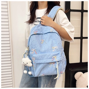 Light blue quilted backpack featuring colorful bow embroidery and cute cloud pendant