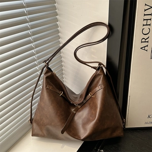 Vintage large brown leather tote bag with adjustable strap in minimalist aesthetic