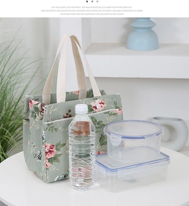 Detail view of floral canvas lunch bag showing capacity for lunch boxes and water bottle