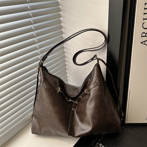 Vintage dark coffee leather tote bag with gold ring buckle and shoulder strap in soft light
