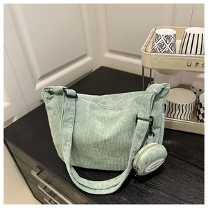 Detailed macro view of light green corduroy tote bag texture and fashion coin purse