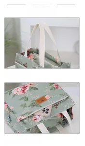 Detail of floral canvas lunch bag with sage green fabric and sturdy beige handles