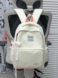 Detail of Korean style backpack with white lace bow charm and pink contrast base