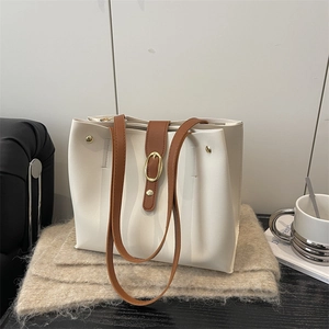 Retro minimalist large tote bag in cream white with brown shoulder straps and gold buckles
