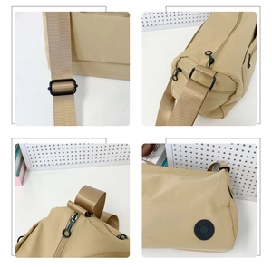Detail view of khaki nylon bag featuring adjustable strap, zipper, and round rubber logo