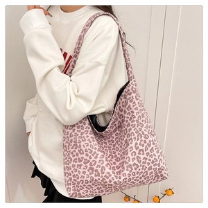 Detailed view of pink leopard print tote bag with soft texture and wide shoulder strap