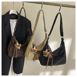 Detailed view of large vintage crescent bags in dark brown, khaki, and black colors