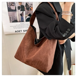 Detail of caramel brown suede hobo bag showing soft matte texture and large capacity