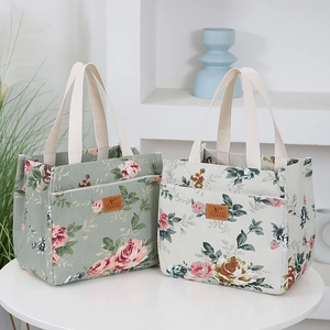 Floral canvas bucket lunch bag with elegant rose pattern and sturdy ribbon handles