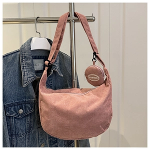 Detail view of pink corduroy crescent crossbody bag with small round coin pouch