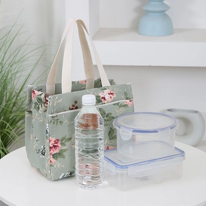 Japanese style floral canvas lunch bag in bean green with a zipper front pocket