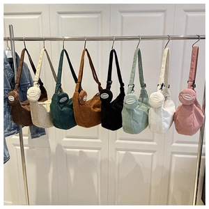 Detail view of corduroy hobo bag set showing eight different colors with matching coin purses