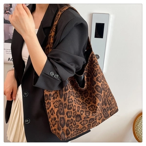 Detailed view of the leopard print faux suede tote bag showing texture and soft shoulder strap