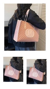 Macro detail of pink tote bag with embossed M logo and monogram print patterns