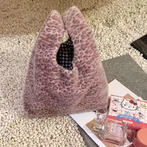 Detail of pink leopard plush tote bag with soft faux fur texture and checkered lining