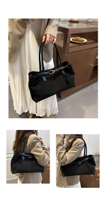 Detail of a black large-capacity suede tote bag with elegant golden D-buckle accents