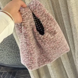 Detail of pink leopard faux fur tote bag with a gingham lining and soft texture