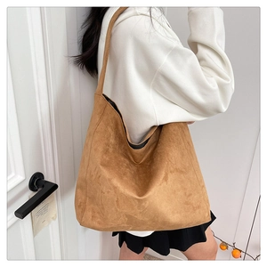 Detail of a large vintage leopard-print suede tote bag shown on a shoulder