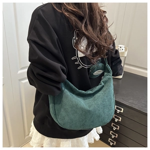 Detail of dark green corduroy crescent shoulder bag with a round coin purse set