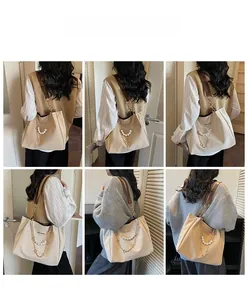 Detail view showing beige tote bag with pearl chain and brown straps on a model