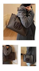 Detailed view of large tote bag with repetitive M letter pattern and round logo