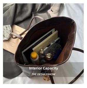 Top view of spacious interior of dark brown vintage leather tote bag with various items