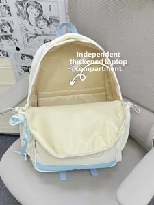 Detail showing internal padded laptop compartment of a cream and blue backpack