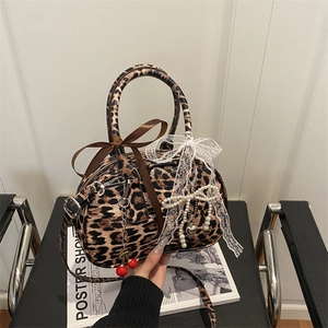 Retro leopard print Boston bag with chic bows, pearl charms, and cherry pendant