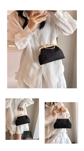 Macro detail of vintage black lace shell bag with golden metal clasp and chain strap