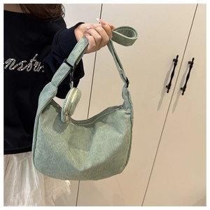Detail of mint green corduroy hobo bag showing ribbed texture and mini round coin purse